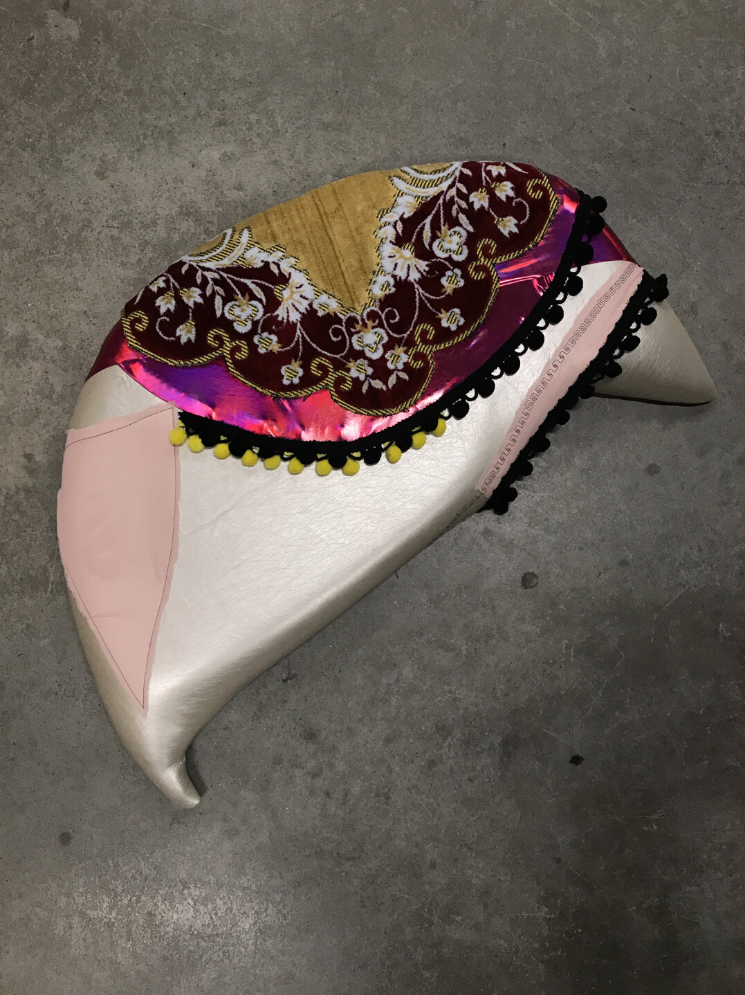 Baseera Khan, Seat 20, Pink and Red, 2019. Pleather, trimmings, prayer rug, chiffon, 24 × 27 × 3 inches