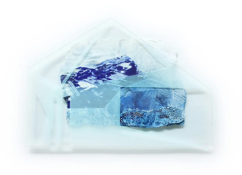 Marianne Chenard, Iceform II Marianne Chenard is a ceramist and visual artist. Her artistic approach reflects her interest in Canadian history, its landscapes, its status as a Nordic country, and the associated clichés and themes that emerge as much in the forms she reinterprets as in the personal imagery she develops. These lend a remarkable consistency to her two creative universes: in situ installations and functional ware. Marianne’s practice is also noted for its exploration of various technical treatments of clay surfaces. Her work has been featured in solo and group exhibitions in Quebec, Canada, and France. She has taken part in several artist residences, with Medalta in Albert and the Maison des Métiers d’Art in Quebec City, among others, and has received an honourable mention from the Prix François-Houdé du Conseil des Métiers d’Art du Quebec and frequently offers specialized training in image transfer techniques. Marianne holds a BFA from Emily Carr University of Art + Design in Vancouver. Originally from Rimouski, she now lives and works in Montreal. Chenard speaks to her practice in her statement: The word “souvenir” in French carries two meanings. One is similar to the English definition as something that serves as a reminder; an object, a collectible, a photograph. The second speaks to the action of remembering: the survival in memory of a sensation, an impression, an idea; an awareness of a past event. My art practice articulates itself around interest in how our connection to the environment is shaped through our personal and collective memories. My works reveal sensitivities to the notion of perception around history, place, memory and absence, and is strongly influenced by an exploration of nature. I use various printmaking techniques on clay and ceramic processes to create sculptures that illustrate fictional but realistic landscapes through imagery, form and contrast of material. I use porcelain, a material with strong historical implications and properties, that is delicate and indestructible at once and which, when fired, becomes an archival artifact. Exhibiting a strong contrast between fragility and permanence, my work explores the indefinite line of what is imagined versus what is actually experienced and the construction of memories.
