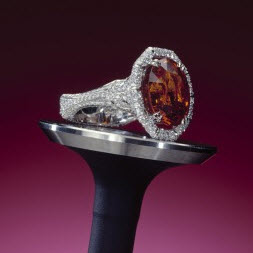 2004 Spectrum - 1st Place Bridal Wear Ricardo Basta Fine Jewelry & E. Eichberg Jewelers; Designer: Ezequiel Safdie Platinum ring featuring a 12.65 ct. orange Garnet accented with Diamonds (1.20 ctw).