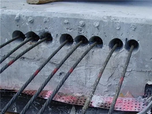 Tendon (cable) tails after tensioning. The cables are pulled to 33,000 pounds, resulting in 8 inches of elongation in a 100-foot cable. 
