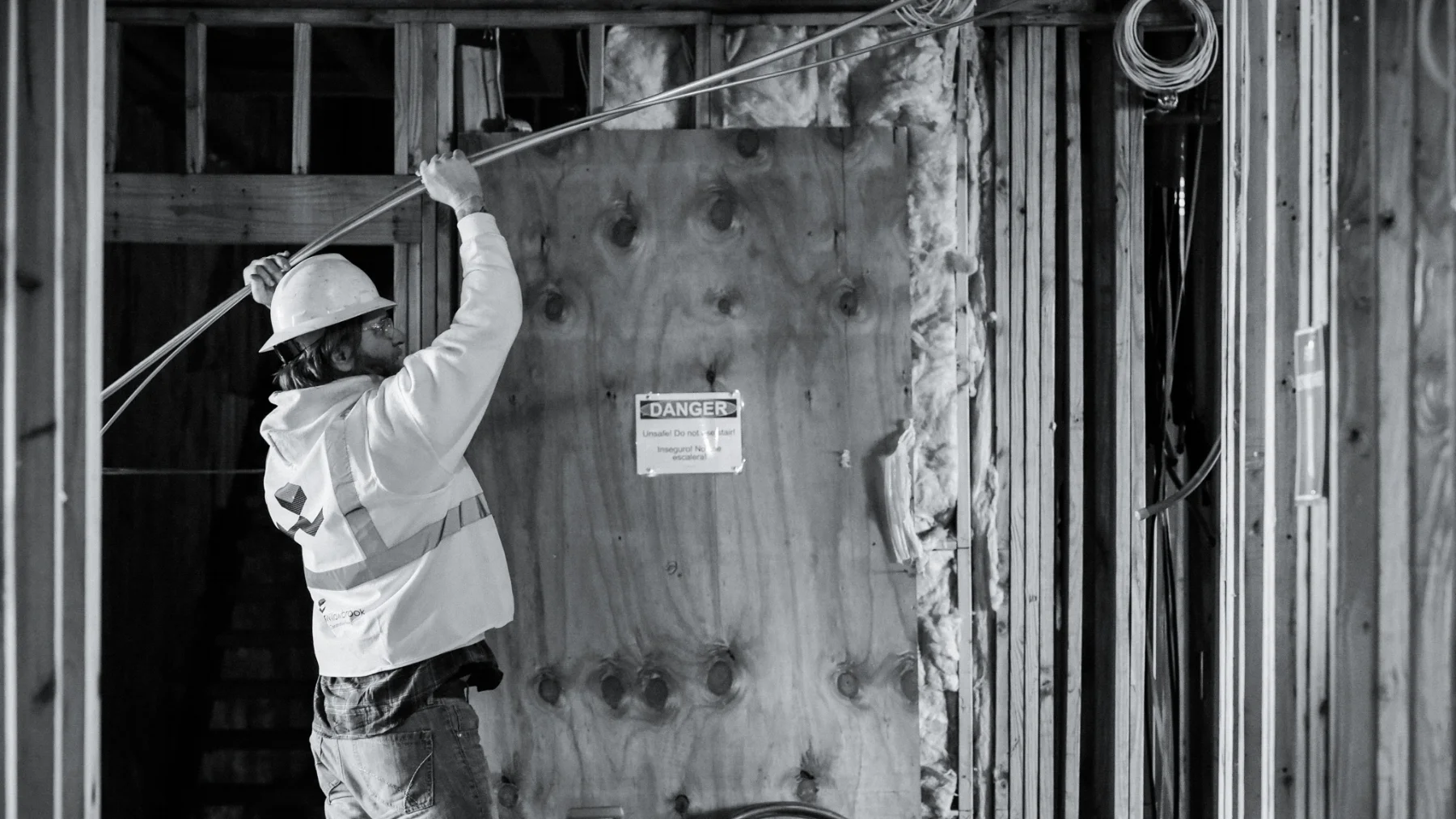 worker running electrical lines b&w.jpg