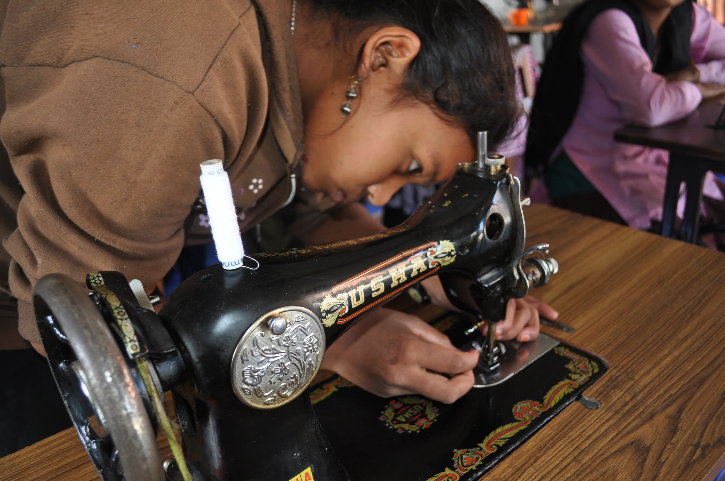 Girl learns to thread needle.JPG