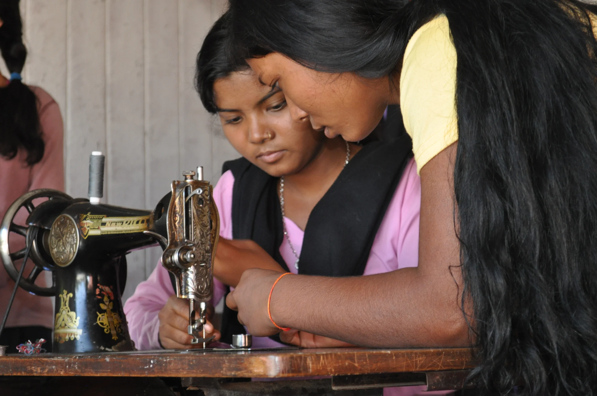 Girls learn to thread.JPG