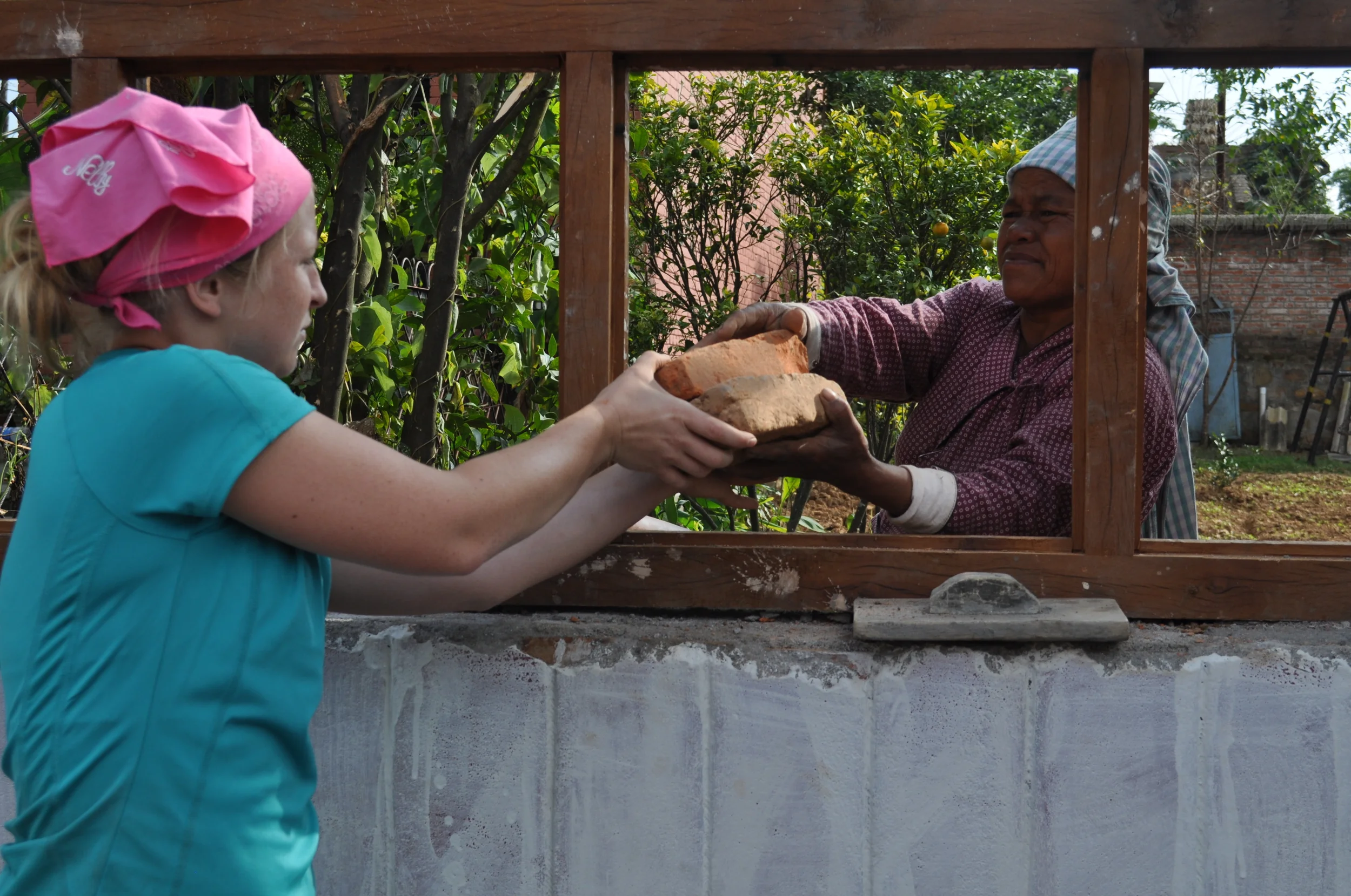 Nikki handing bricks.JPG