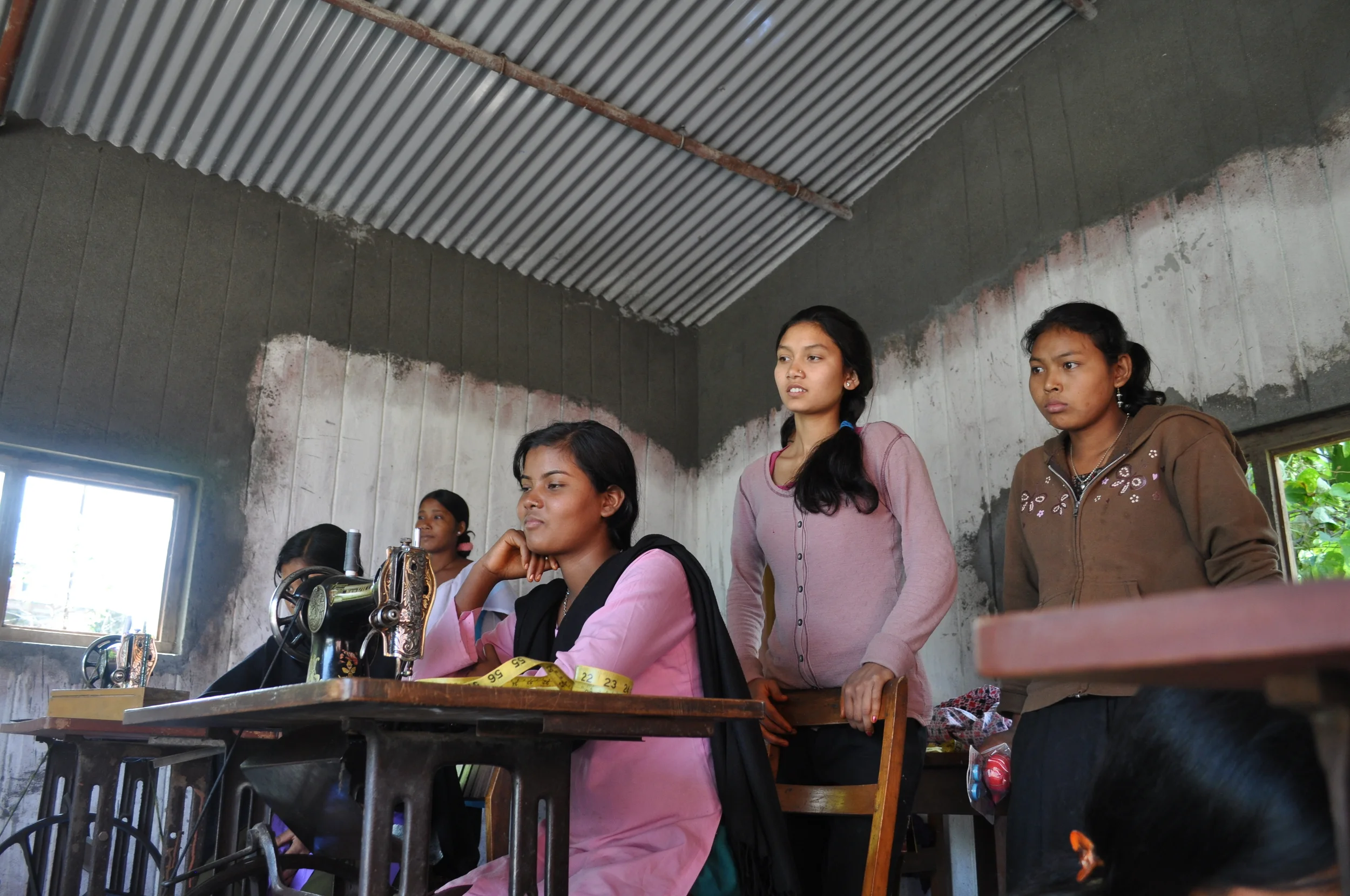 Women listening in sewing room.JPG