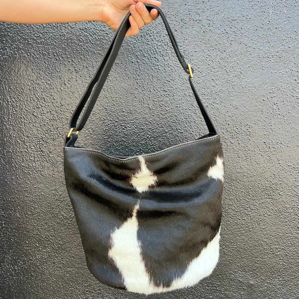 PRIMECUT: BLACK + WHITE COWHIDE BUCKET BAG