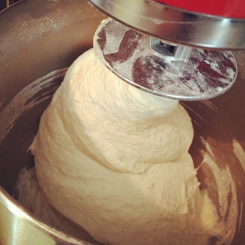  Mix the dough on low speed for 2 minutes. Then add 1 tbsp salt and mix on medium speed for 6-8 minutes. Do this until the dough stops sticking to the sides of the bowl. If you need to make it less sticky, throw a little more flour in there. 