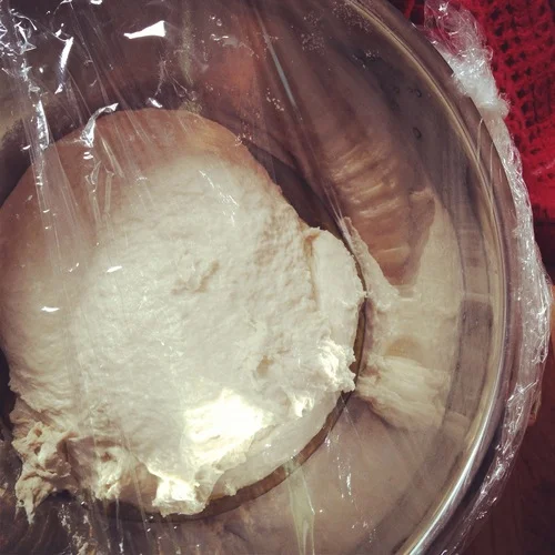 While this is going on, grease a large bowl (big enough for the dough to double in size) with olive oil. Put the dough in the bowl and plastic wrap it for a second time. Set aside for 45 min. Like Biggie Smalls once did, get ready to “love the dough.”