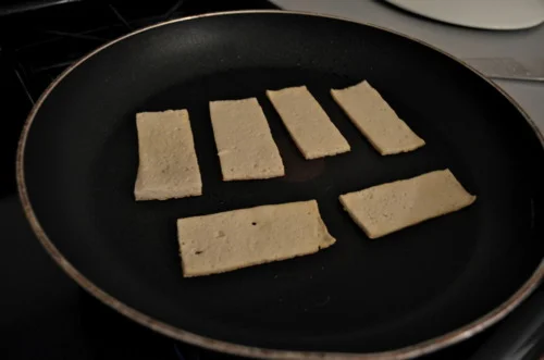 B) All you need to do is heat a pan with some vegetable oil, and then plop ‘em down. Secret: You will get the urge to check on them, touch them, flip them, talk to them, etc. DON’T. Don’t disturb the magic that is cooking tofu.