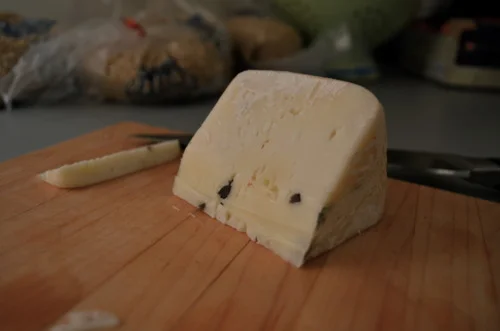 Caciotta tartuffo cheese. “A young, springy Sheep’s Milk toma, laced with flecks of Black Truffle. Heady yet refreshing.” (Just a couple of slices to place on top of the mushrooms…)