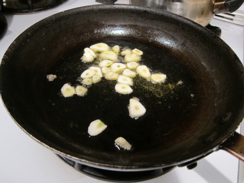 Pour a good amount of olive oil into the pan because this will essentially be your sauce. Toss garlic in. Don’t let it burn.