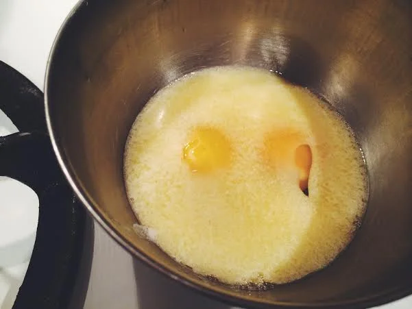 Combine two eggs and two melted sticks of butter together. Some casual "Mom in the Kitchen" advice was to gradually pour the melted butter out instead of waiting for all of it to melt. You don't want to burn your butter. 