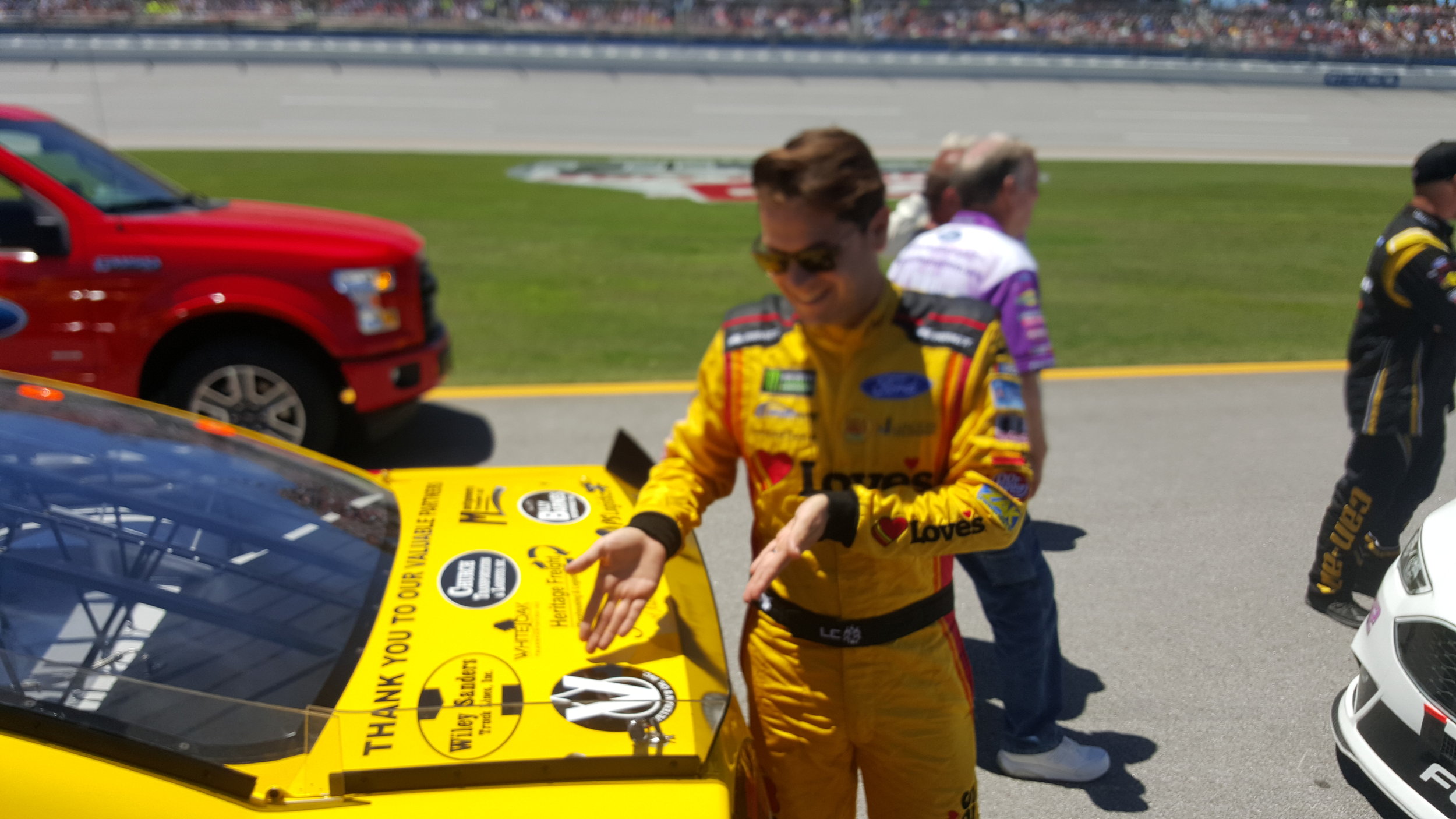 Landon showing our sponsorship on the car-2.jpg