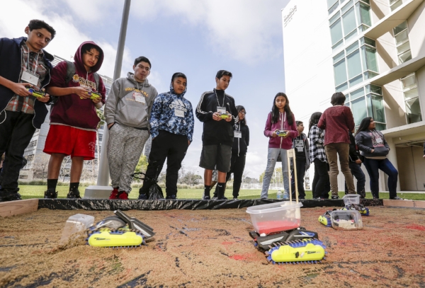 Students have fun with robots representing osteoblast and osteoclast cells at the Stem Cell Day of Discovery event held at the USC Health Sciences Campus in Los Angeles, CA. February 4th, 2017. The event encourages students to learn more about STEM opportunities, including stem cell study and biotech, and helps demystify the fields and encourage student engagement. Photo by David Sprague