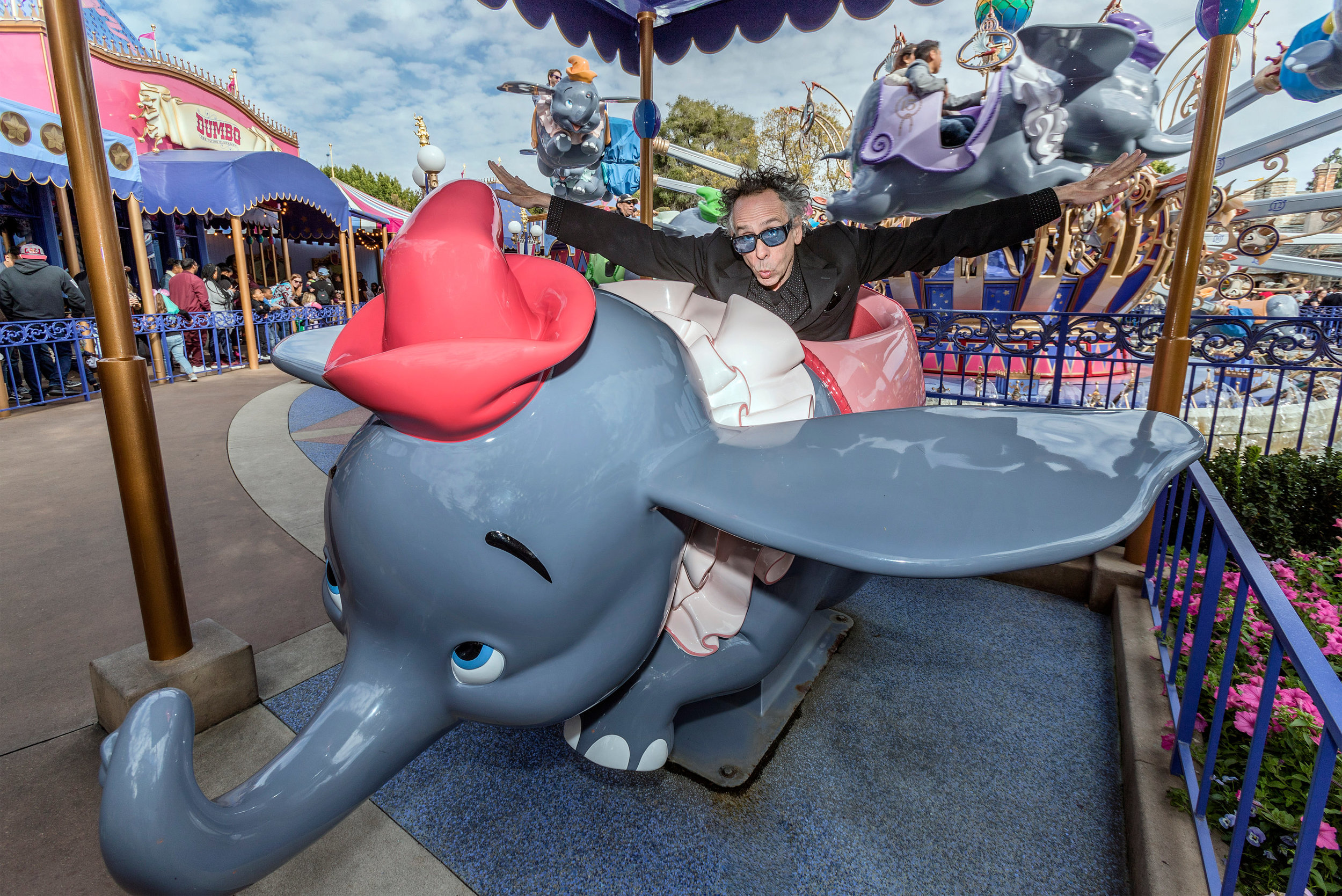 Director Tim Burton poses with Dumbo the Flying Elephant at Disneyland Park in Anaheim, Calif., March 9, 2019, to celebrate the upcoming grand live-action adventure �Dumbo,� in theaters March 29. For a limited time, a sneak peek of the film can be seen in the Main Street Opera House at Disneyland Park. (Joshua Sudock/Disneyland Resort)