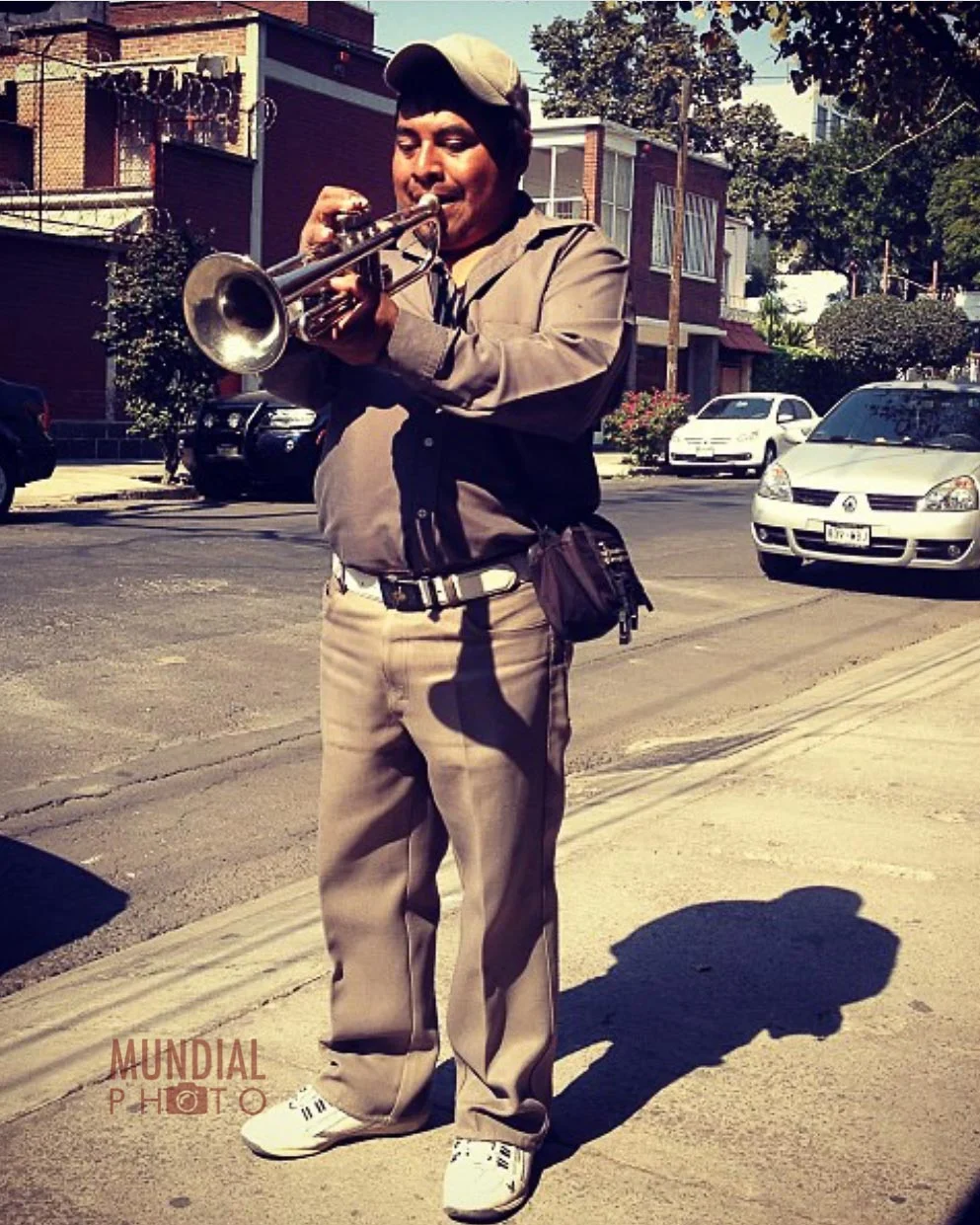 Even in a quiet side street on a sunday morning, music is a way of life in Mexico City. I captured this performer after hearing him walking from street to street playing for anyone that would listen to earn money for his songs. I could have sat and finished my breakfast but as a photographer, something inside should always say "move, photograph and experience". you never know if you'll see the same thing again.