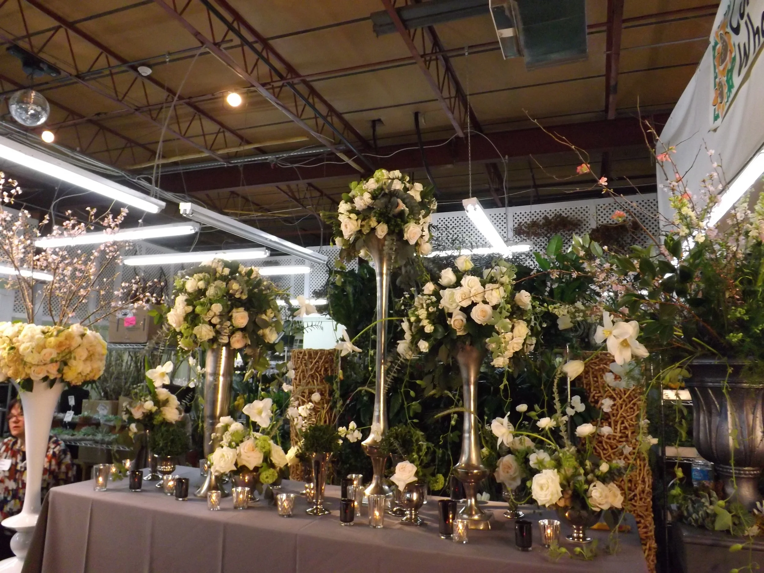 Classic style table scape with beautiful silver containers, ivory, white and green flowers. Similar to my classic style I think, but a bit messier. 