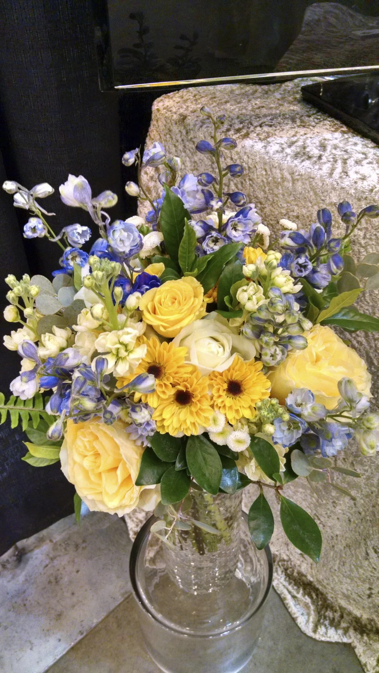 Delphinium, viking daisies, roses, stock, feverfew