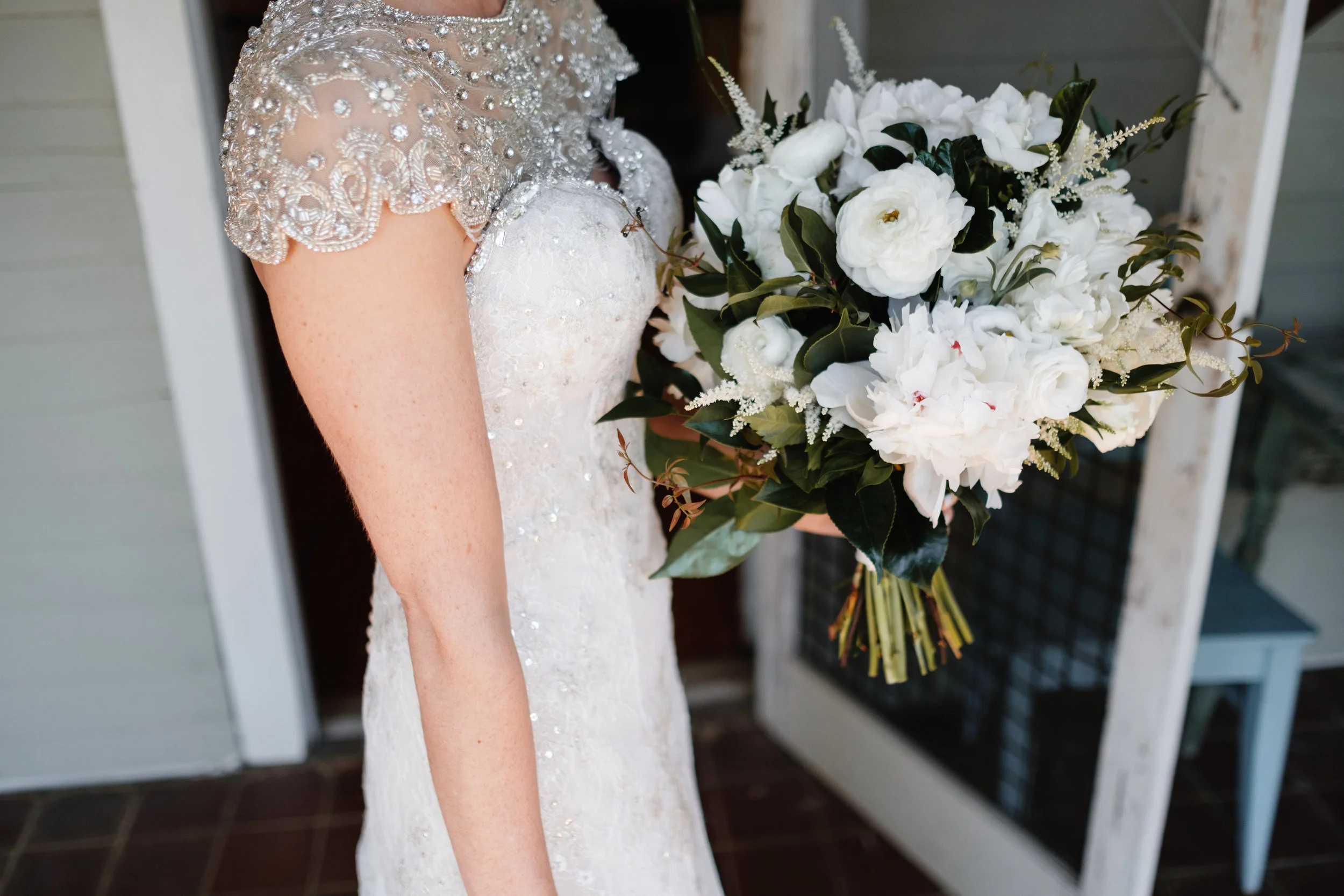 Peonies, Ranunculus, Astilbe, Camellia and Gardenia foliage, Jasmine vine. Photo by Joe and Selah Photography. The Barn at High Point Farms, GA.