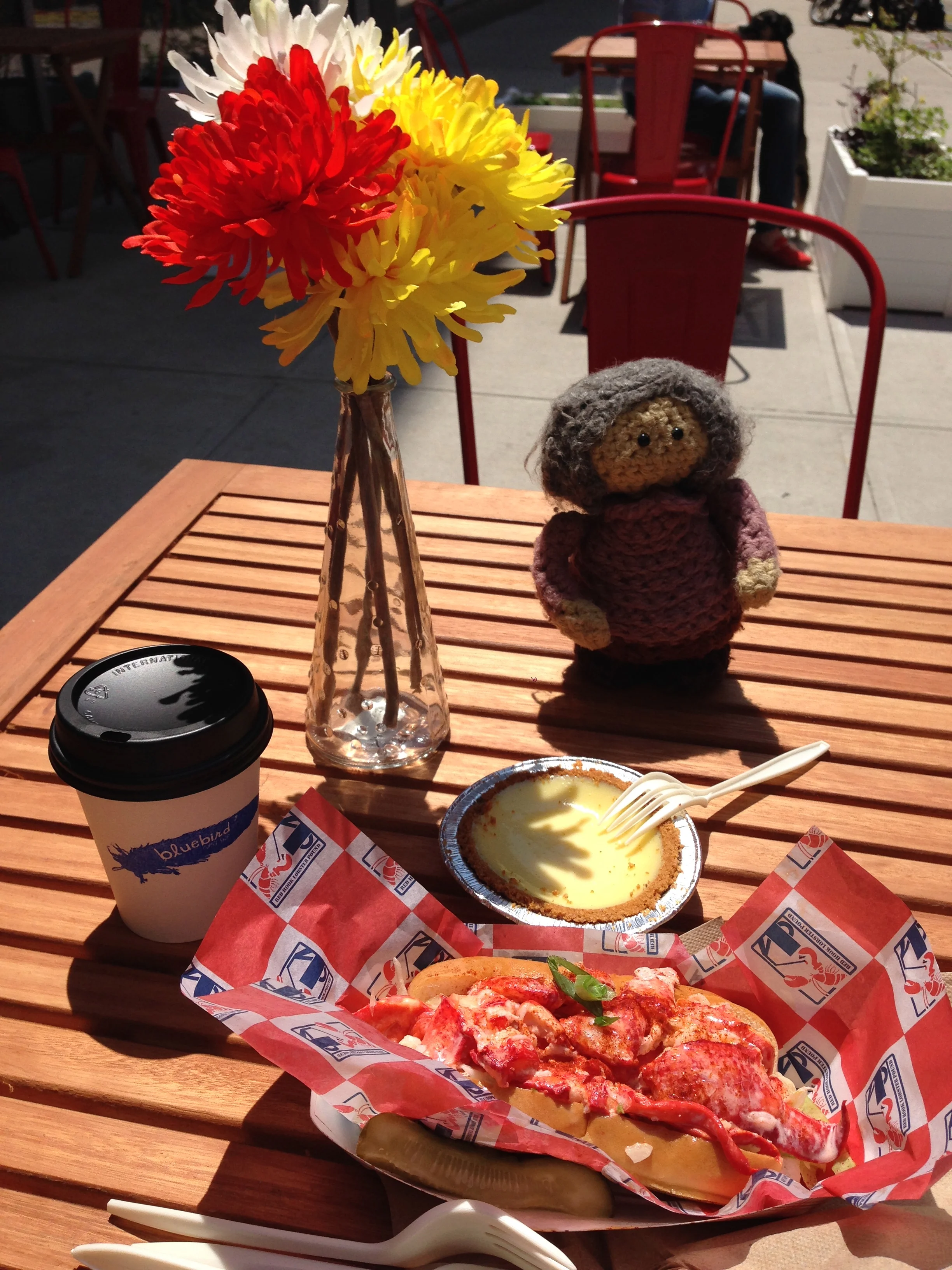 Alice presides over a post-brunch snack: Red Hook Lobster Pound 's Maine roll, Steve's key lime pie , and delicious flat white from Bluebird .
