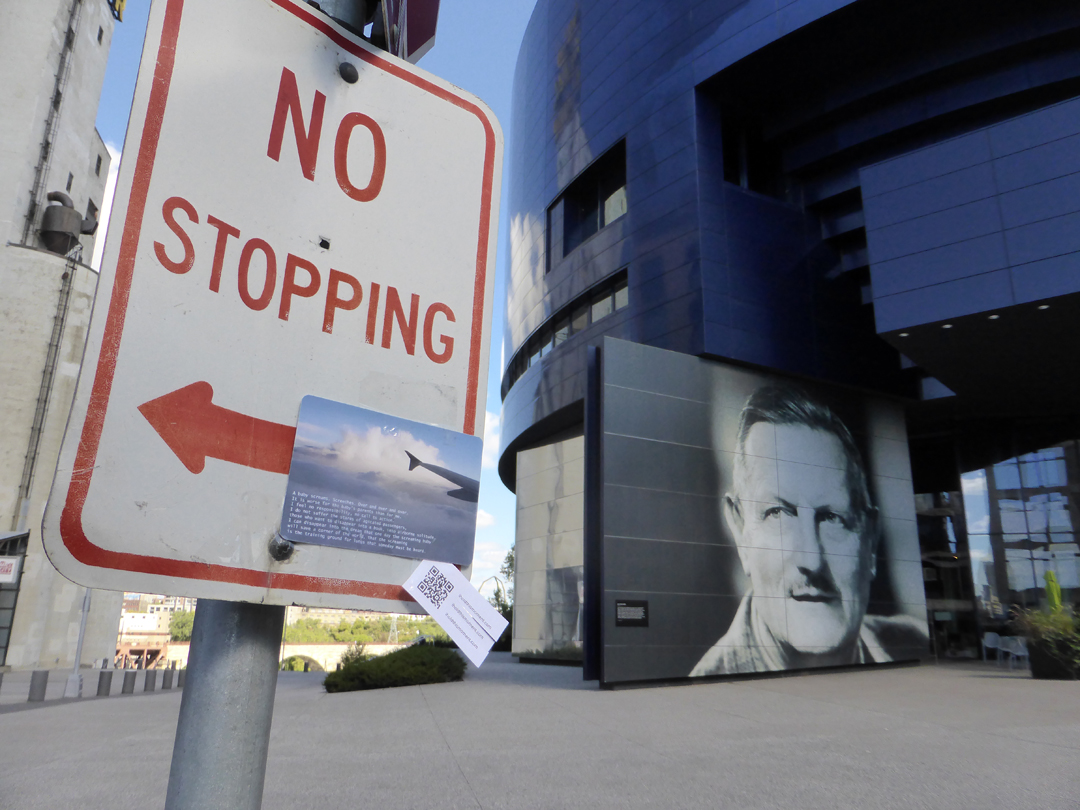between the new Guthrie Theatre and a very old flour mill which exploded in the 1980's and whose shell is now the location of a farmer's market on Saturdays. Tyrone Guthrie glances to a nearby postcard.