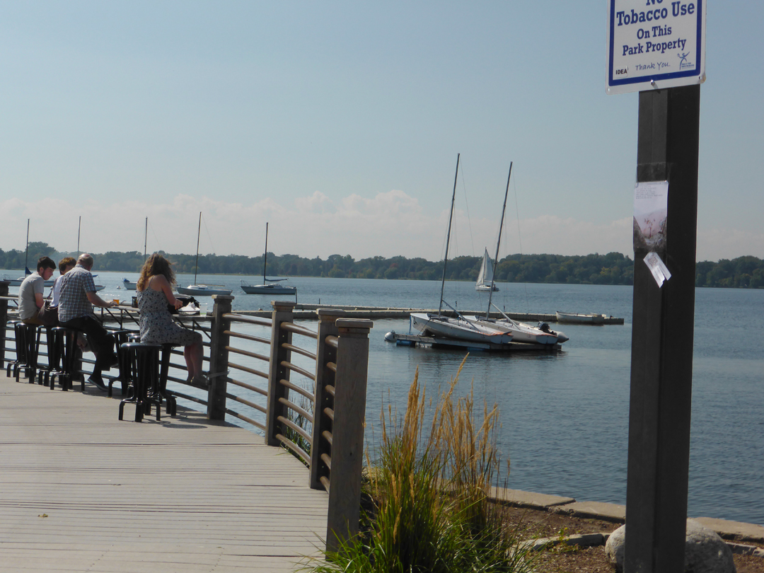next to Lake Calhoun, which is in the middle of the city, where there is a junction of bikers, pedestrians, and an outdoor eatery.