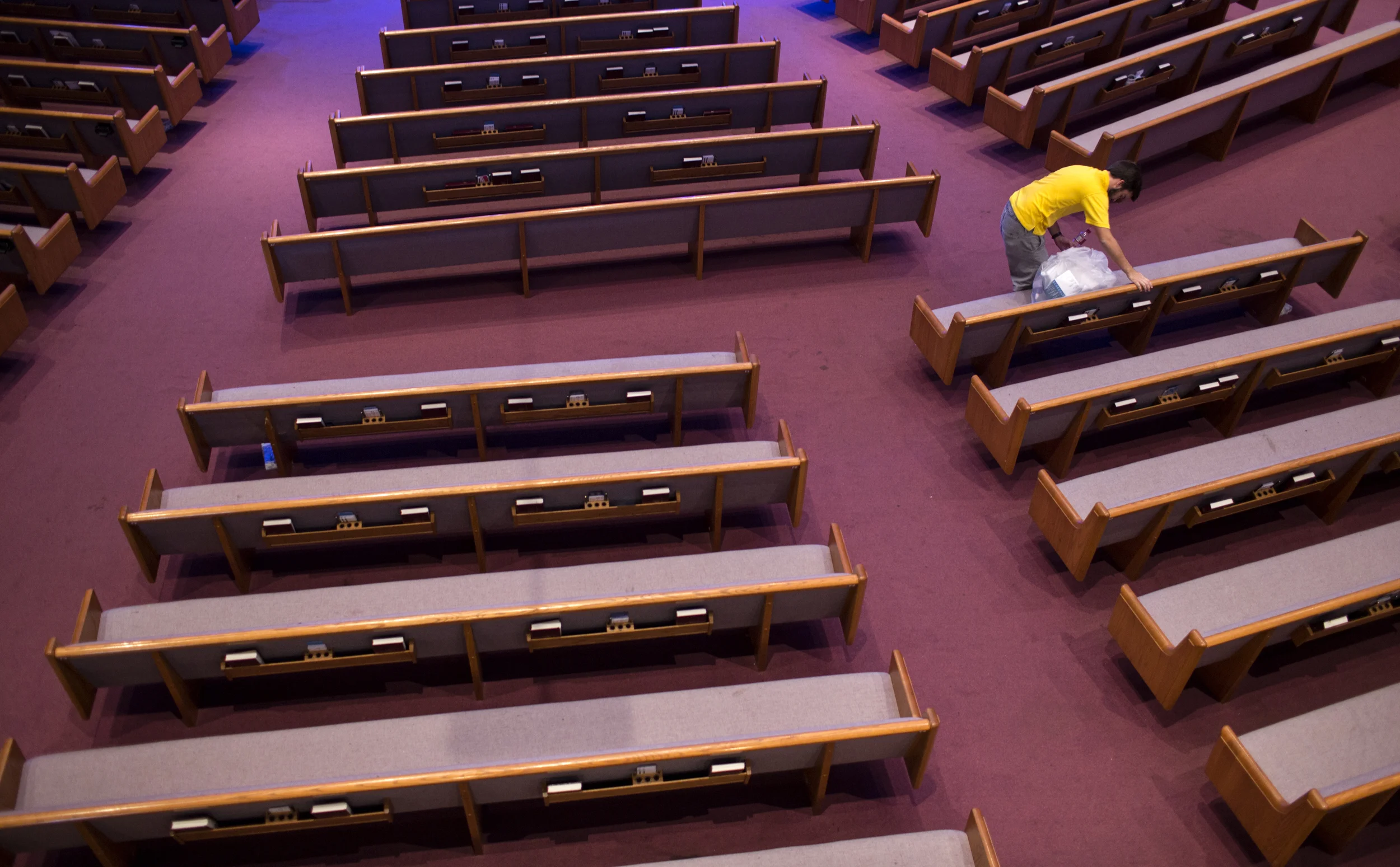A young boy cleans up after the Potomac Men's Conference at the Trinity Life Church in Lutherville, Maryland. Several thousand men attended the conference where they celebrated their love for Christ and learned how to utilize his teachings in their daily lives. 
