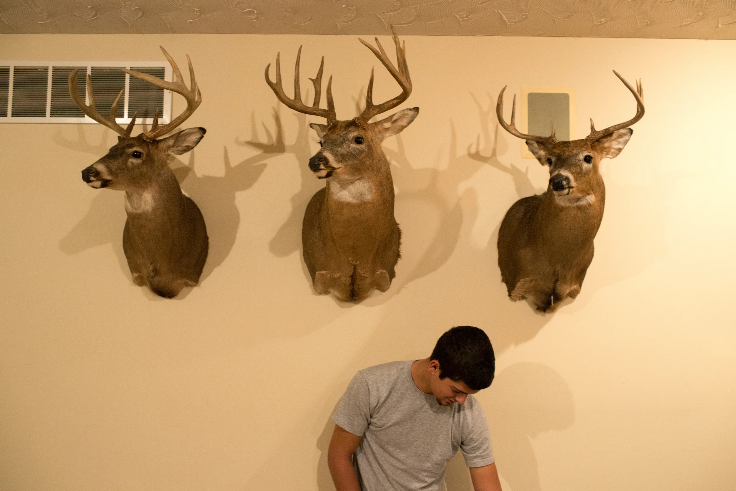 Tracy's son-in-law, Dale, stands against a wall in their family home in Eldersburg, Maryland.