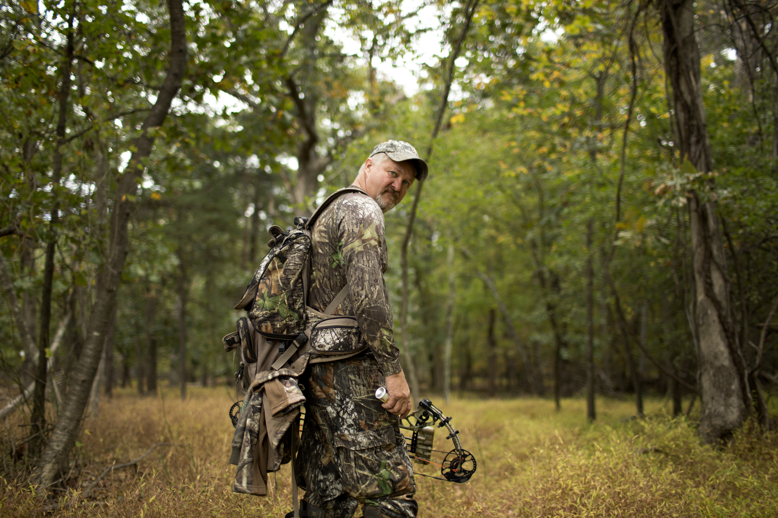 Tracy Groves stands on the edge of a forest on his way to a tree stand during his first hunt of the 2015 Maryland deer season. 