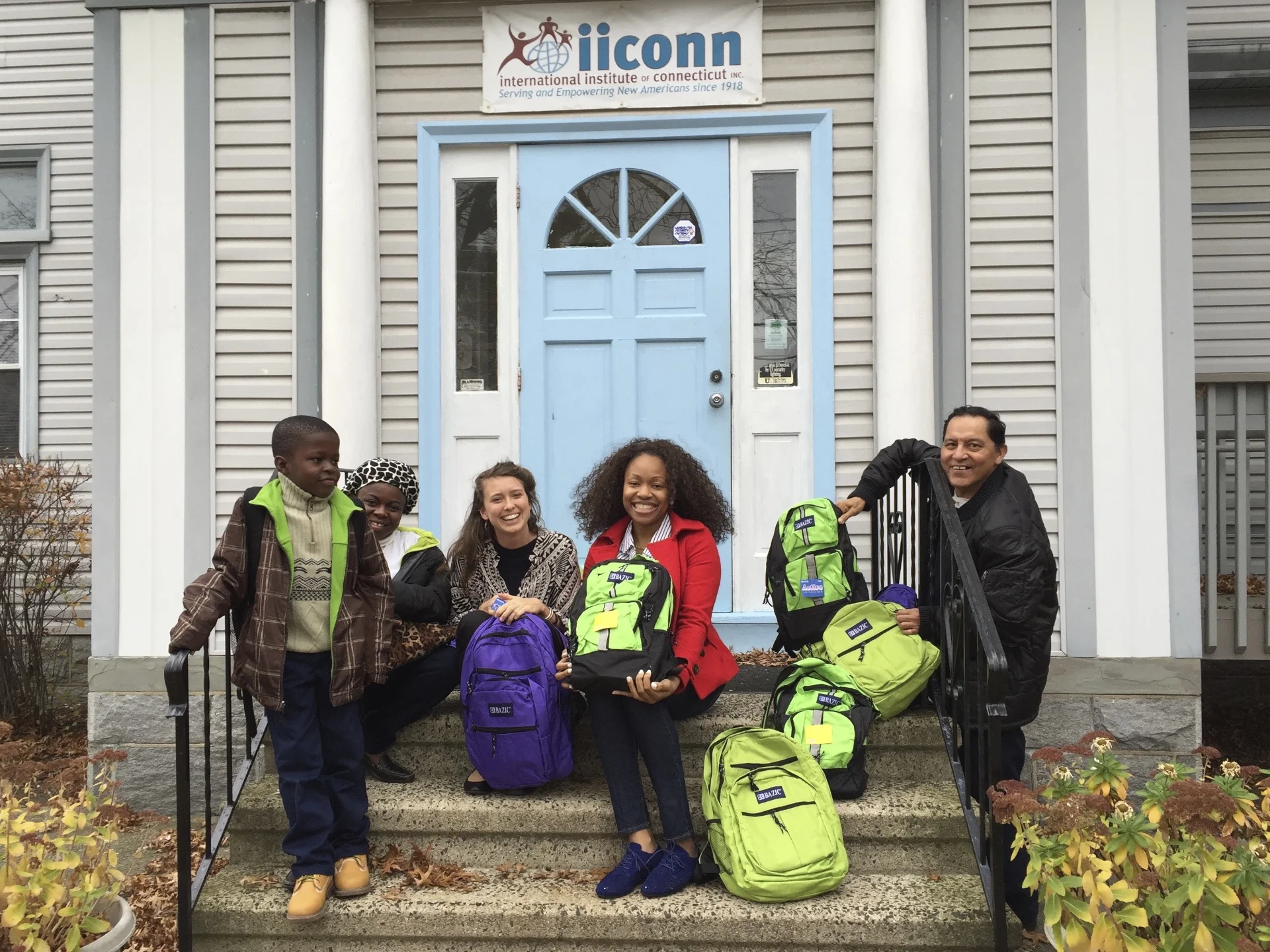 Helen and Doyin of IICONN with one of their client families and Julio from Books4Everyone in front of their headquarters in Bridgeport 