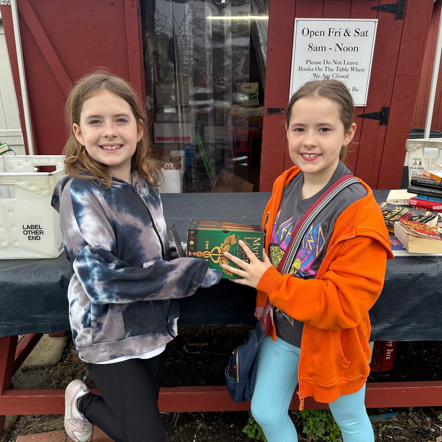 MacKenzie and Collins dropped by to donate  their books and to find new treasures.