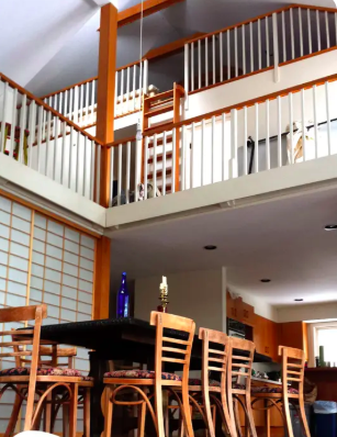 The view from the living room up onto the second floor and the sleeping loft accessible by ladder