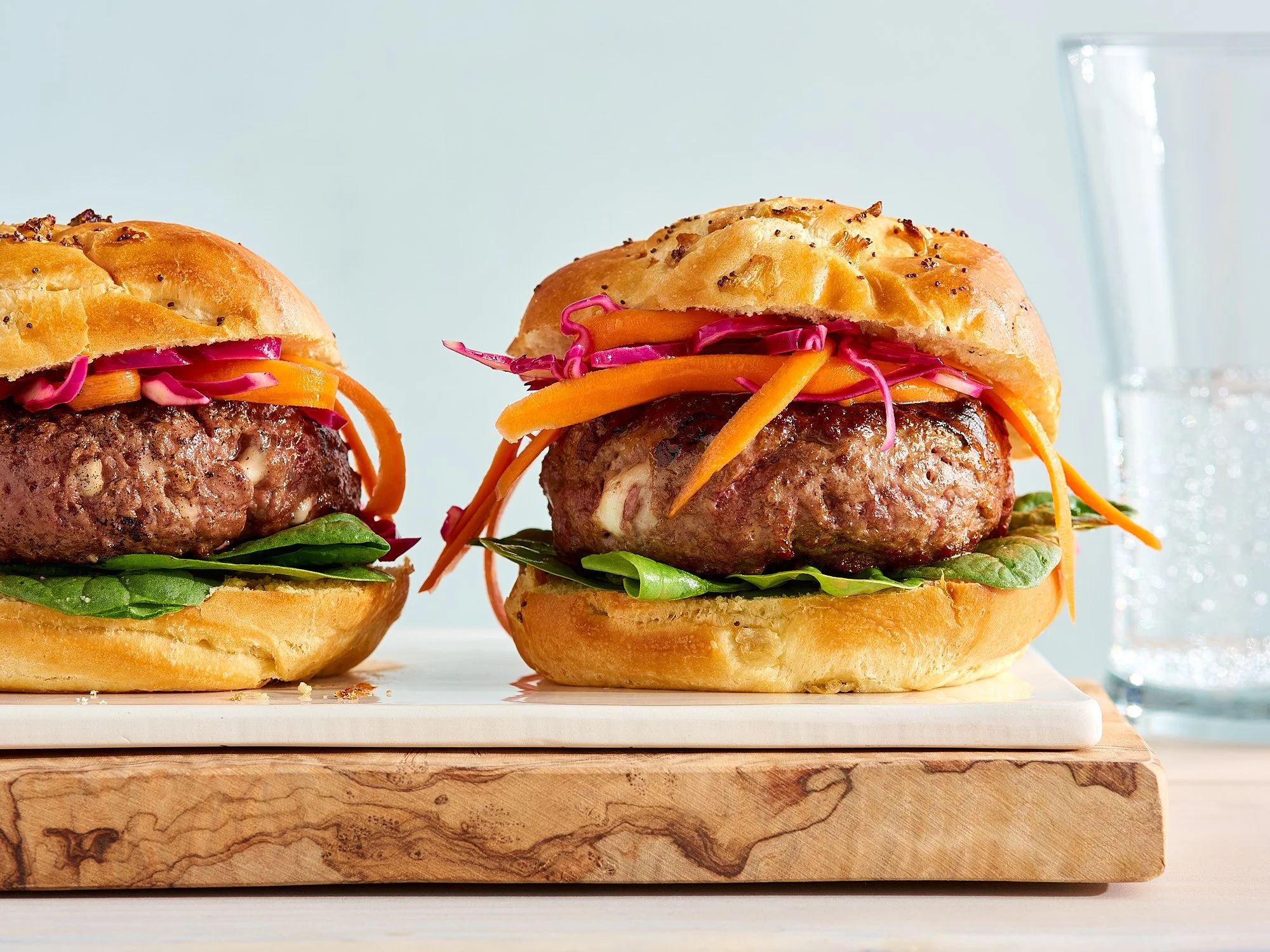 Commercial food photography by Dhanraj Emanuel — plant-based NoBull burgers with colorful toppings on toasted brioche buns, shot for NoBull Burger. Food advertising photographer for CPG brands and agencies, working nationally.
