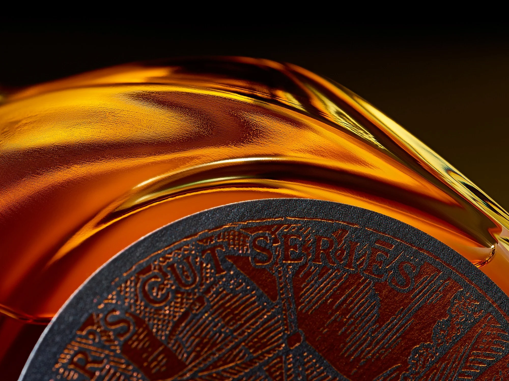 Conceptual advertising photography by Dhanraj Emanuel — dramatic close-up of gold coin with detailed engravings against dark background. Commercial conceptual photographer for advertising agencies and editorial clients, available nationwide.