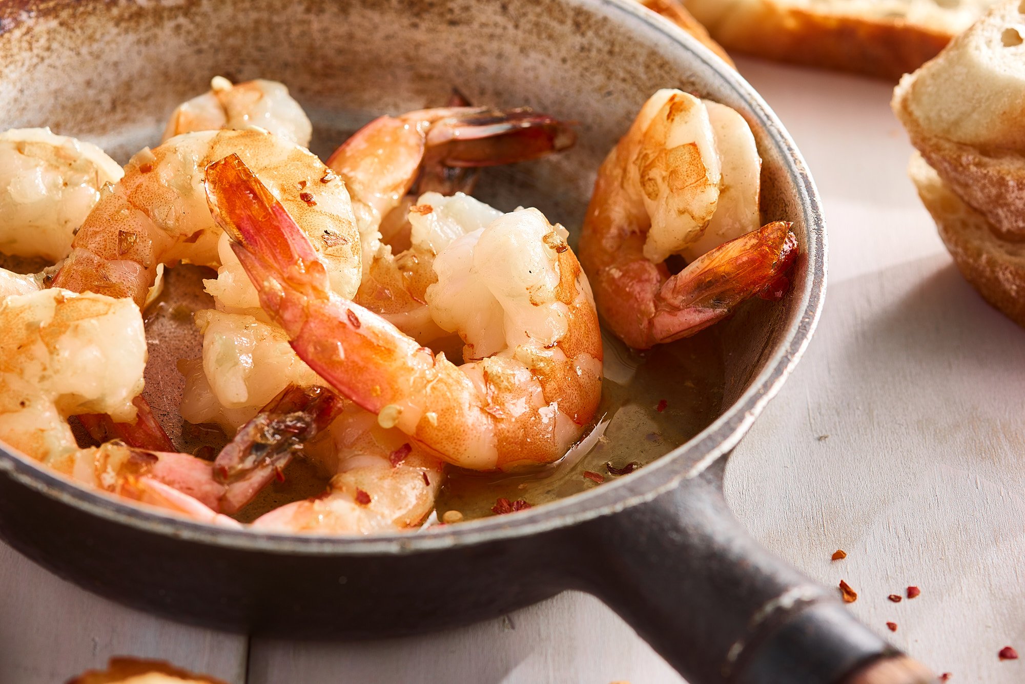 Shrimp scampi dark pan warm directional light The Fresh Market food advertising photography by Dhanraj Emanuel, CPG food photographer Greensboro NC