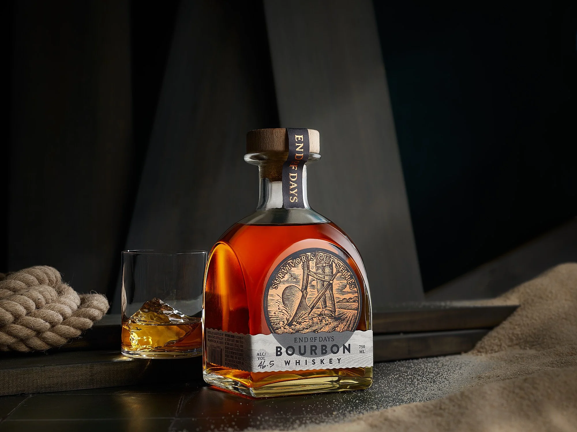 End of Days Bourbon whiskey bottle with glass and ice — commercial food and beverage advertising photographer Dhanraj Emanuel | craft spirits photography for brands and agencies | available nationwide