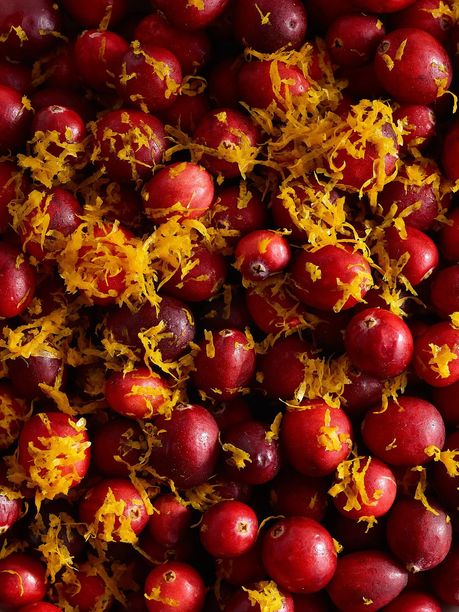 Cranberries with lemon zest Thanksgiving overhead dark food advertising photography by Dhanraj Emanuel, CPG food photographer NC