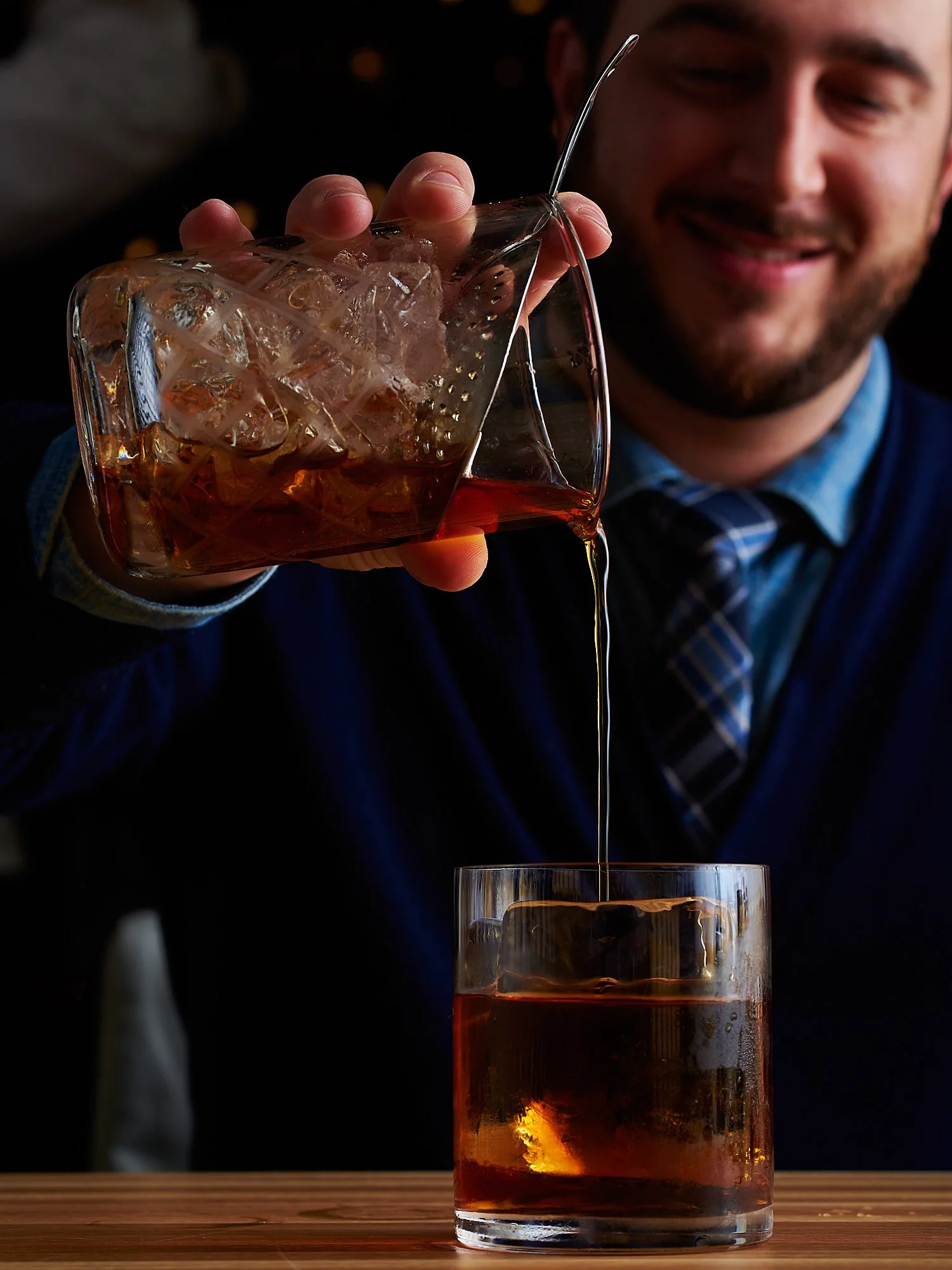 Restaurant and beverage advertising photography by Dhanraj Emanuel — bartender pouring cocktail into iced glass, lifestyle drink photography for restaurants and spirits brands. Commercial food and beverage photographer working nationally for agencies