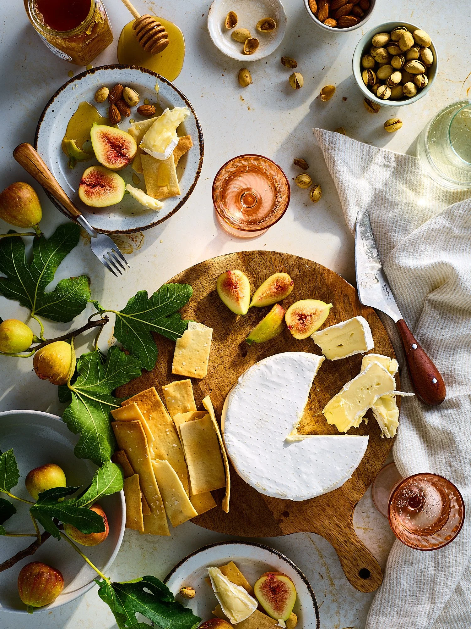 Brie cheese board figs honey pistachios rosé wine overhead editorial food advertising photography by Dhanraj Emanuel, CPG food photographer Greensboro NC