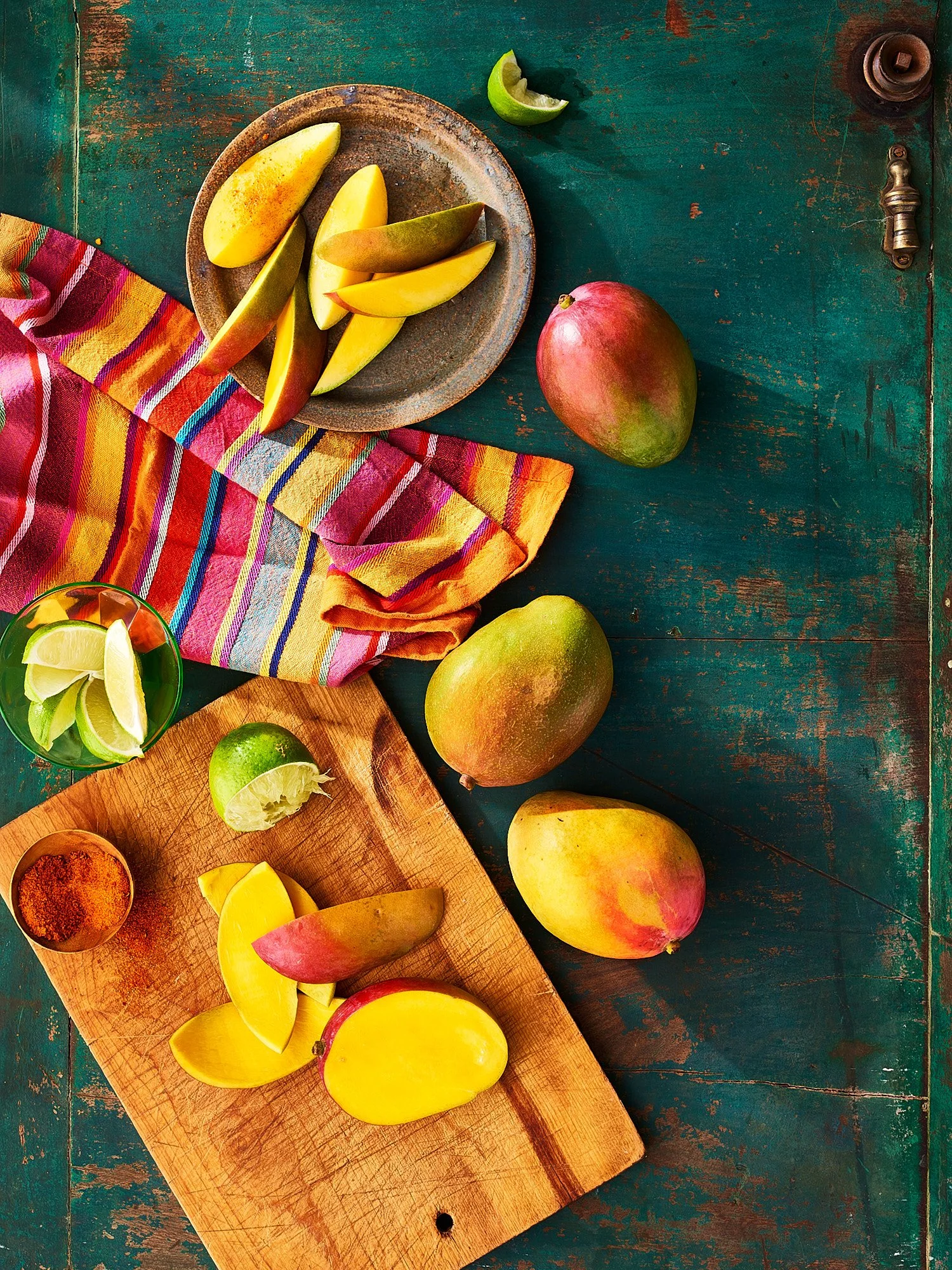 Commercial food photography by Dhanraj Emanuel — fresh mangoes with lime on rustic cutting board, editorial food photography for Our State Magazine. Food photographer working nationally for editorial and CPG clients.
