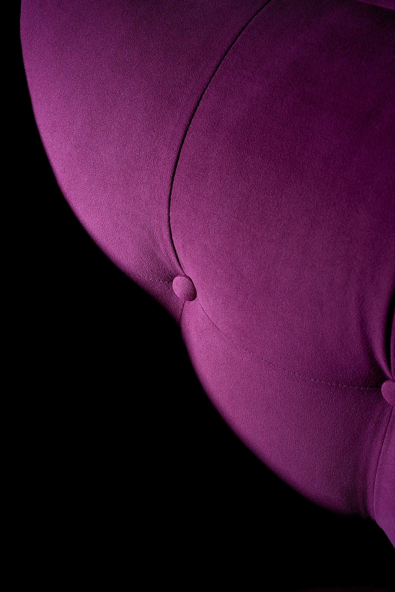 Ultrasuede magenta tufted sofa close up dark dramatic Toray International advertising photography by Dhanraj Emanuel, product photographer Greensboro NC