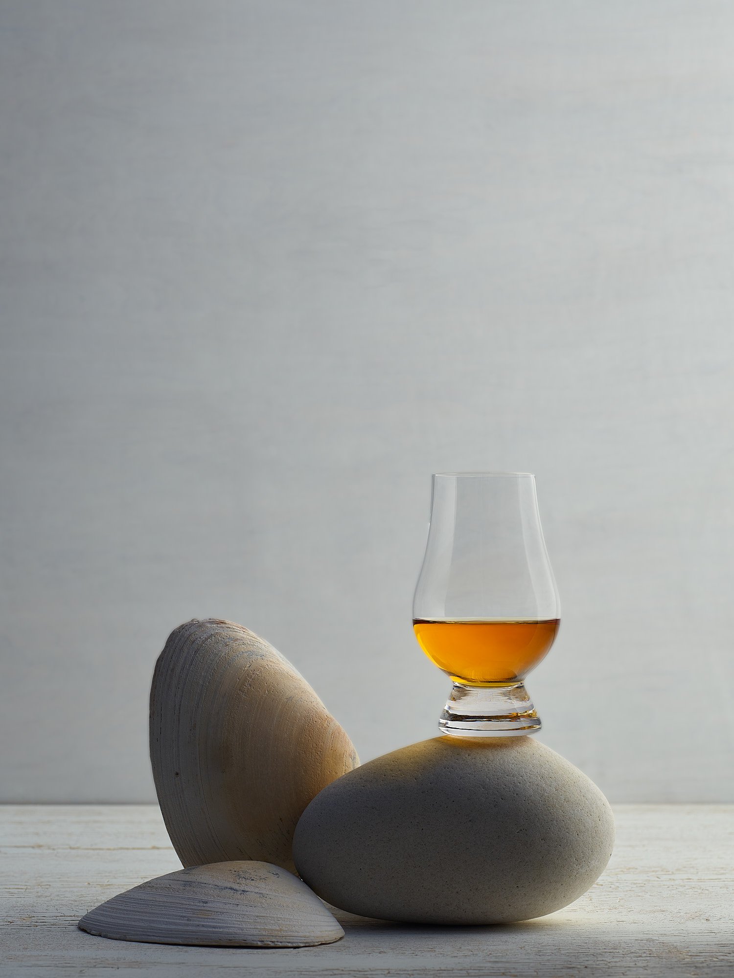 Scotch whisky Glencairn glass stones minimal elegant spirits advertising photography by Dhanraj Emanuel, beverage photographer Greensboro NC