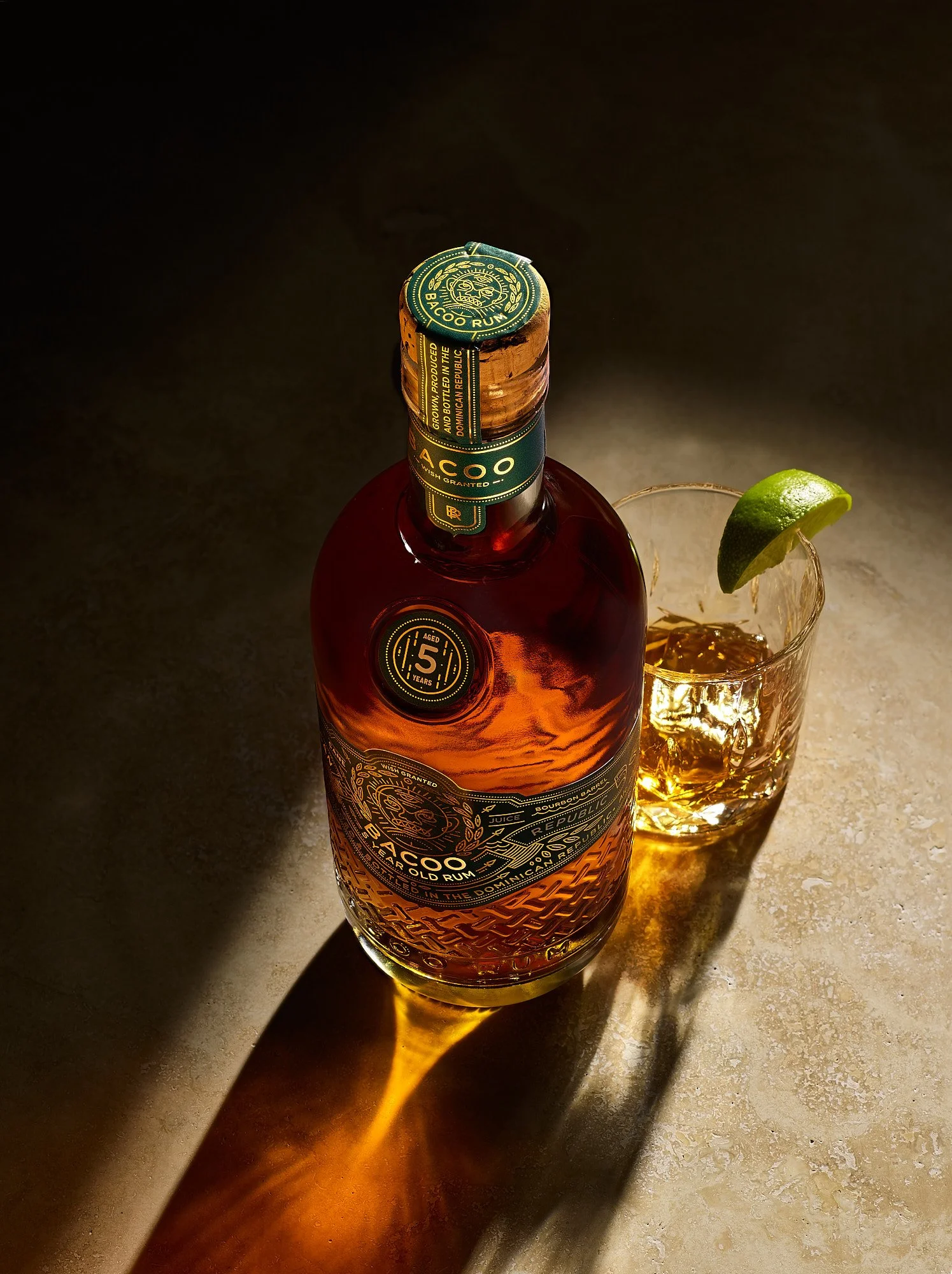 Bacoo 5 Year Dominican rum bottle cocktail dramatic shadow geometry beverage advertising photography by Dhanraj Emanuel, spirits photographer Greensboro NC