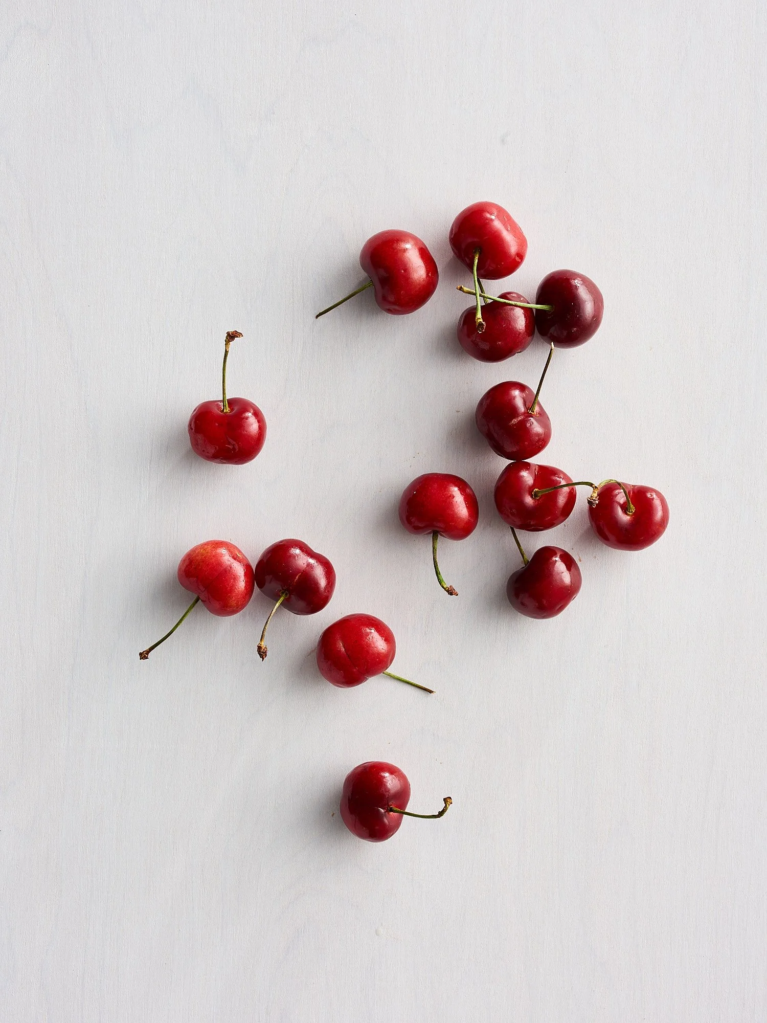 Cherries on white minimal CPG food advertising photography by Dhanraj Emanuel, studio food photographer Greensboro NC