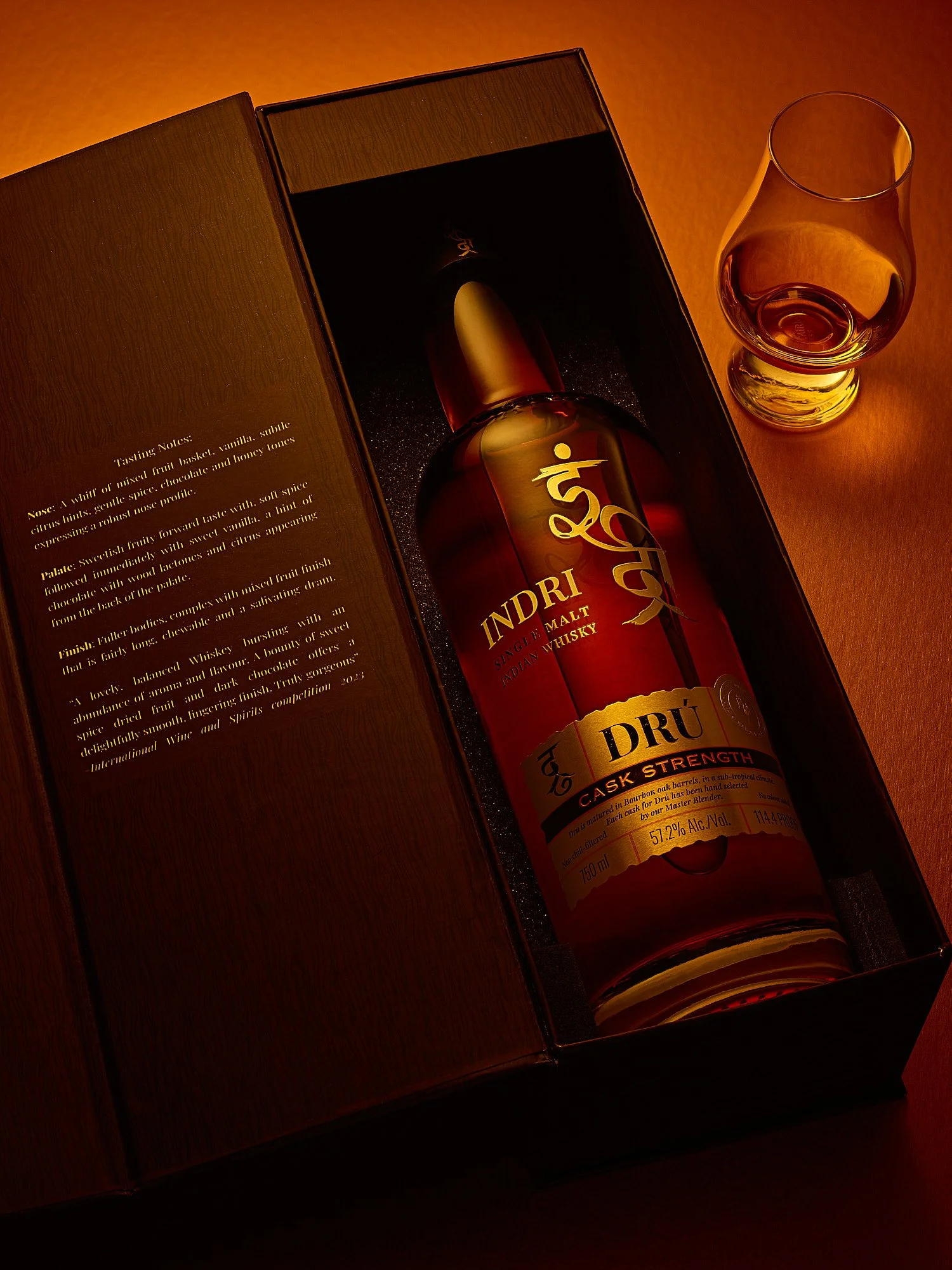 Spirits advertising photography by Dhanraj Emanuel — Indri Indian single malt whisky in wooden presentation box with warm dramatic lighting, shot for Piccadily Distilleries. Commercial beverage photographer working nationally for premium spirits bran