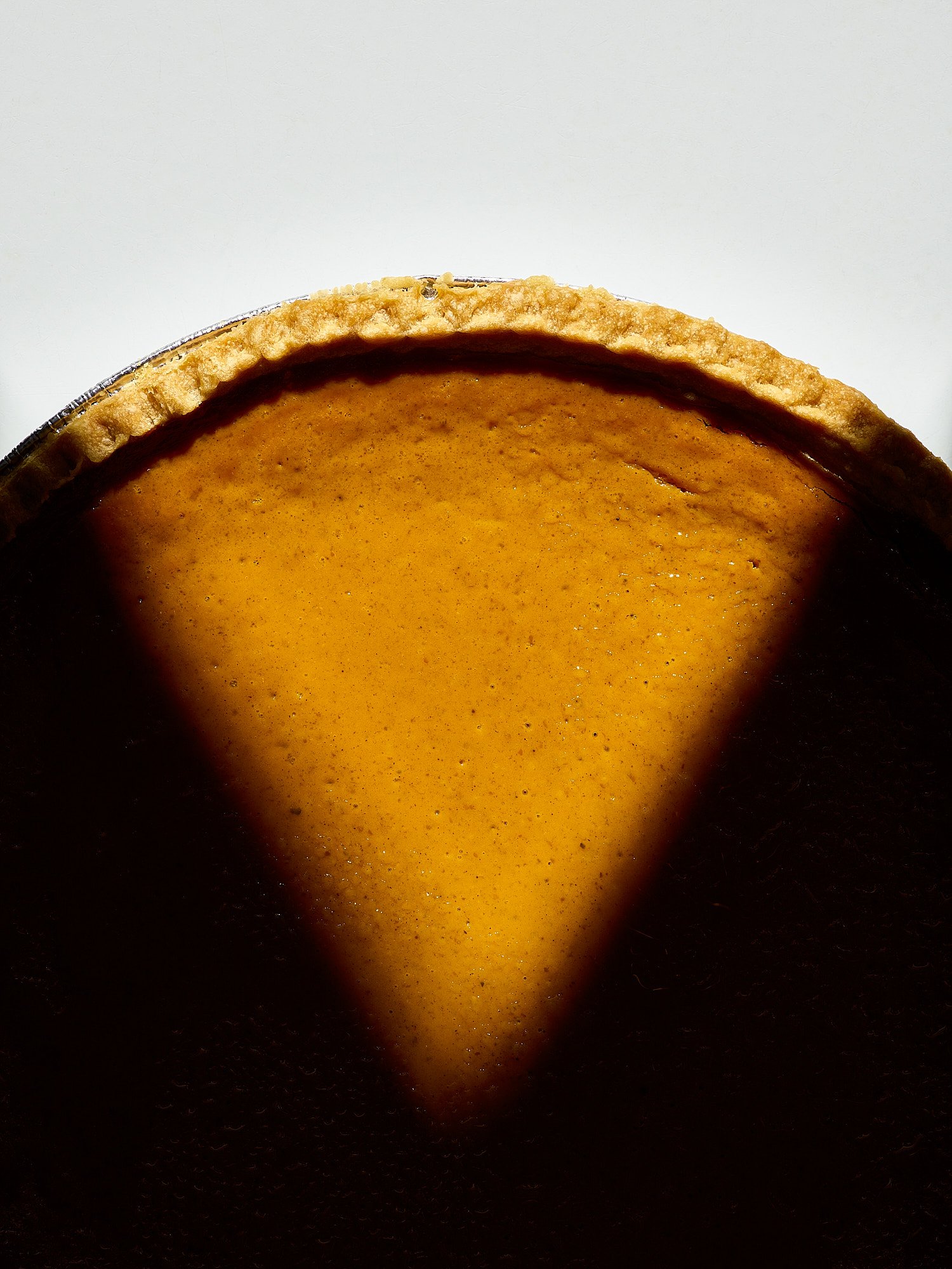 Costco pumpkin pie golden crust close up Thanksgiving food advertising photography by Dhanraj Emanuel, CPG food photographer Greensboro NC