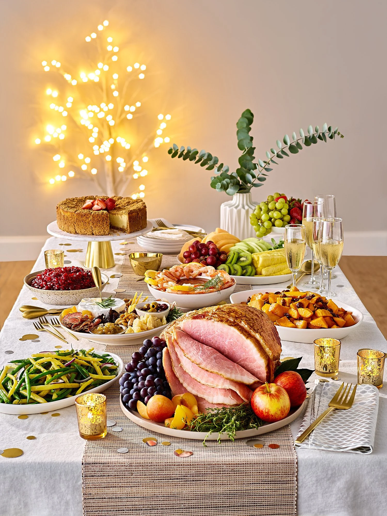 Commercial food photography by Dhanraj Emanuel — festive holiday table with roasted ham, seasonal sides, and champagne, shot for The Fresh Market. Food advertising photographer for CPG and grocery brands, available nationwide.