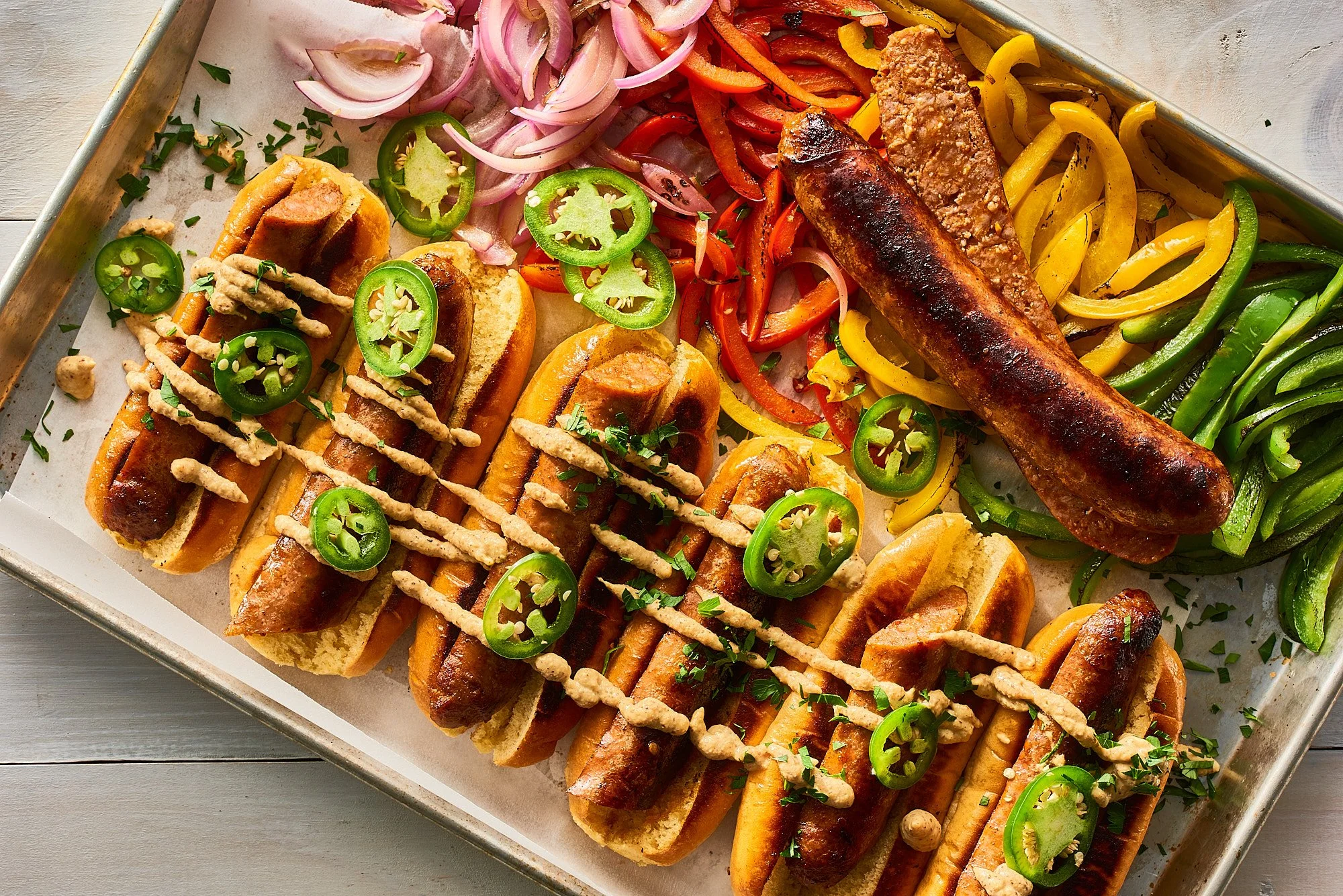 Food advertising photography by Dhanraj Emanuel — grilled sausages with jalapeños, peppers, and onions on a tray, shot for Myron Mixon Keto BBQ. CPG food photographer for brands and advertising agencies, available nationwide.