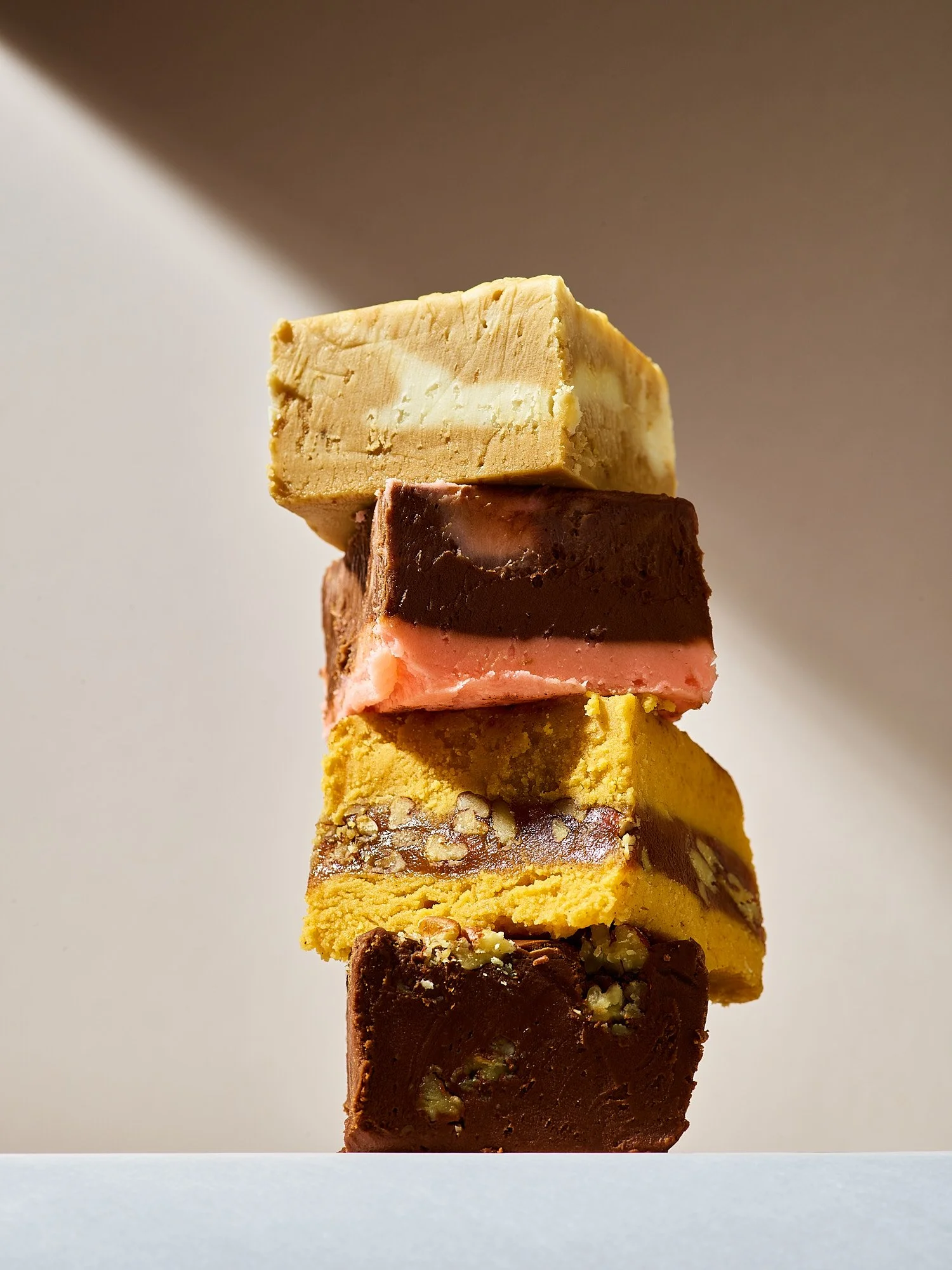 Lexington candy stacked fudge blocks gold dramatic light product photography  for our state magazine by Dhanraj Emanuel, confectionery photographer Greensboro NC
