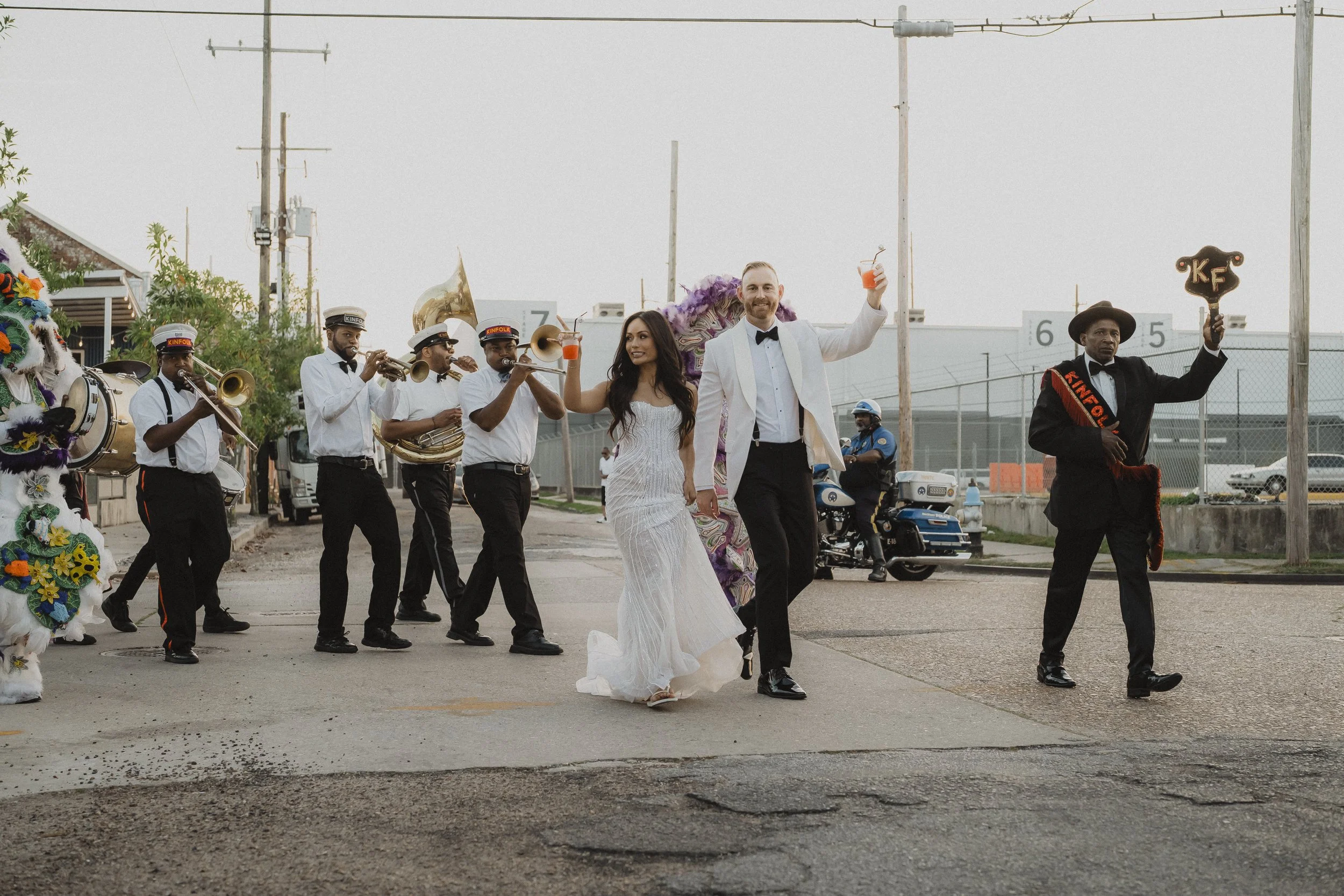 Wedding couple dancing in the street with their second-line band